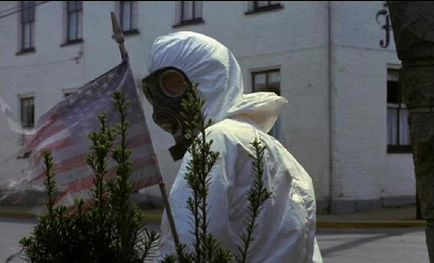 Un soldat en combinaisont avec un drapeau américain à l'envers dans The Crazies